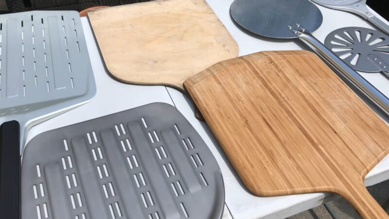 Wooden and metal pizza peels on the table