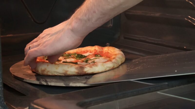 Rotating the pizza in the oven with the pizza peel