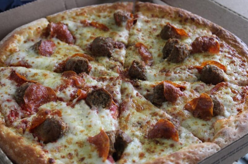 Close-up of a pizza topped with meatballs and pepperoni